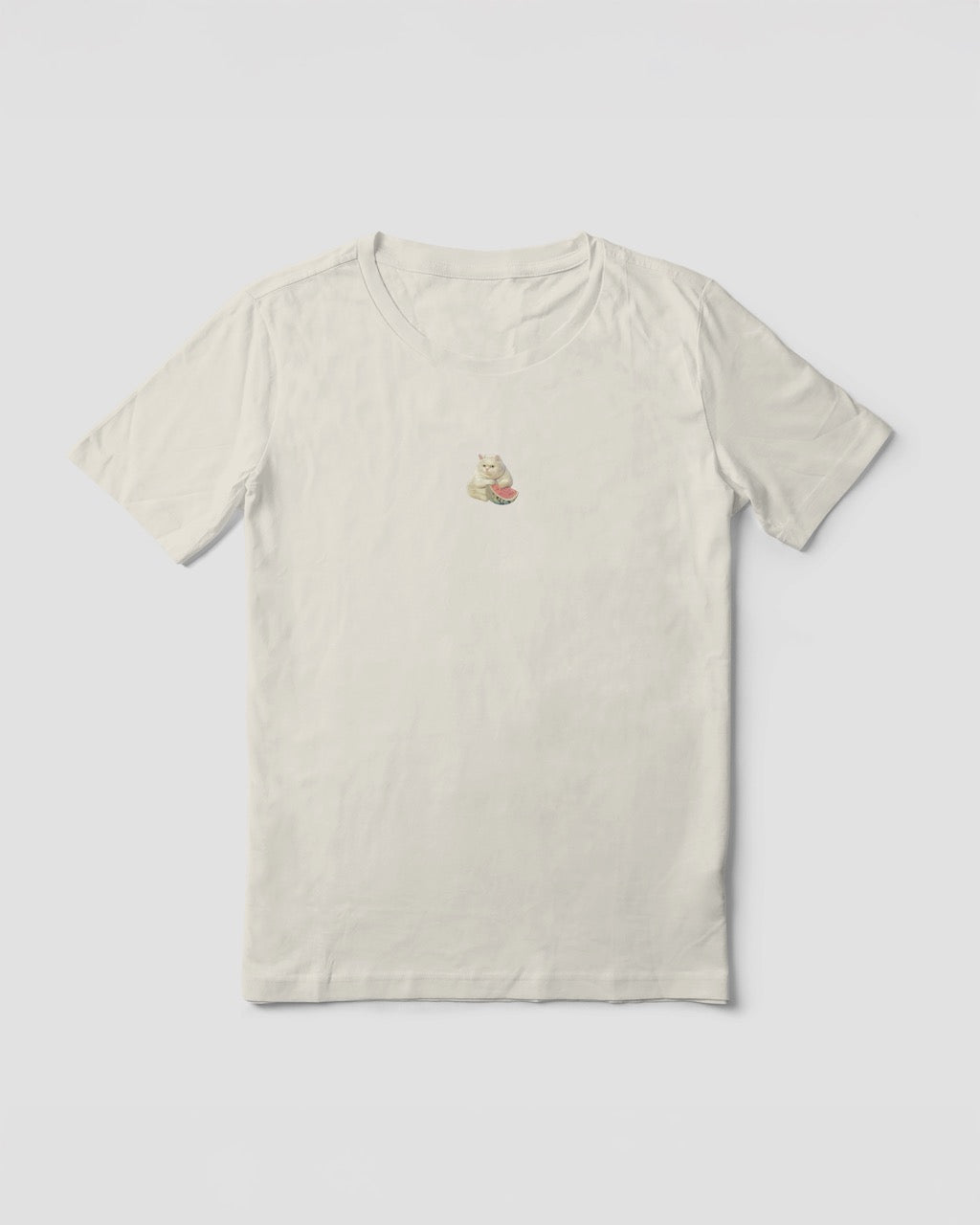 Women's off-white natural organic cotton Geoff & Jeffrey t-shirt with a small graphic print of a funny fat cat (Jeffrey) holding a watermelon. The t-shirt has a cute aesthetic.
