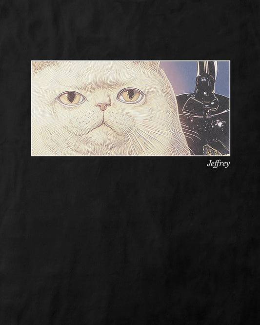 Close up of a women's black organic cotton Geoff & Jeffrey t-shirt with a framed graphic print of a funny fat cat (Jeffrey) poker-faced and a kettle at his side. With his name 'Jeffrey' subtly printed in Libre Baskerville below the image. The t-shirt has a cute aesthetic
