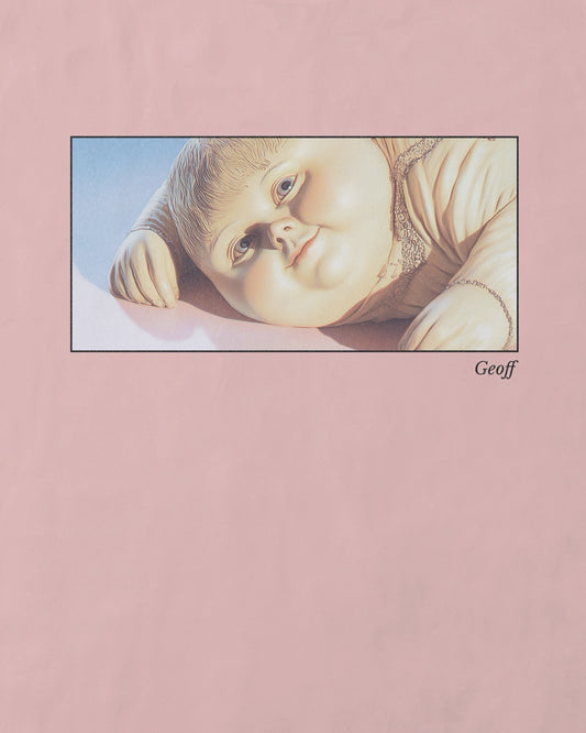 Close up of women's soft pink organic cotton Geoff & Jeffrey t-shirt with a framed graphic print of a jolly, proud boy (Geoff) looking slightly upwards, with his name 'Geoff' subtly printed in Libre Baskerville below the image. The t-shirt has a dreamy aesthetic