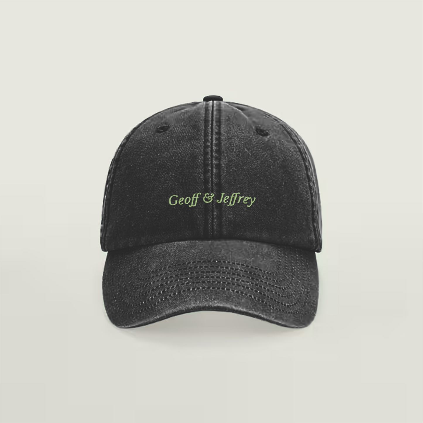 Front view of Geoff & Jeffrey vintage black dad cap with green embroidery