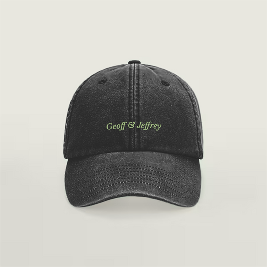 Front view of Geoff & Jeffrey vintage black dad cap with green embroidery