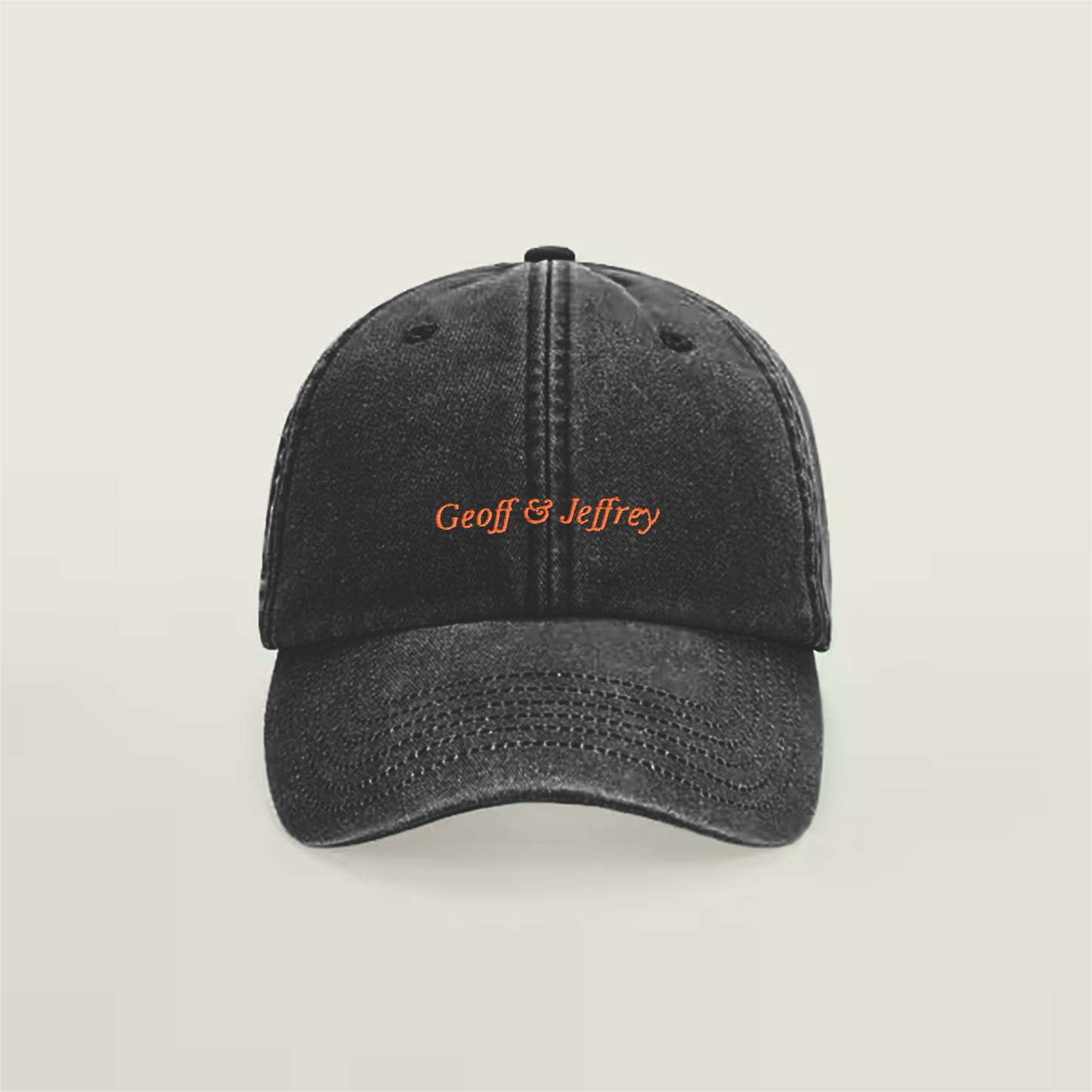 Front view of Geoff & Jeffrey vintage black dad cap with orange embroidery