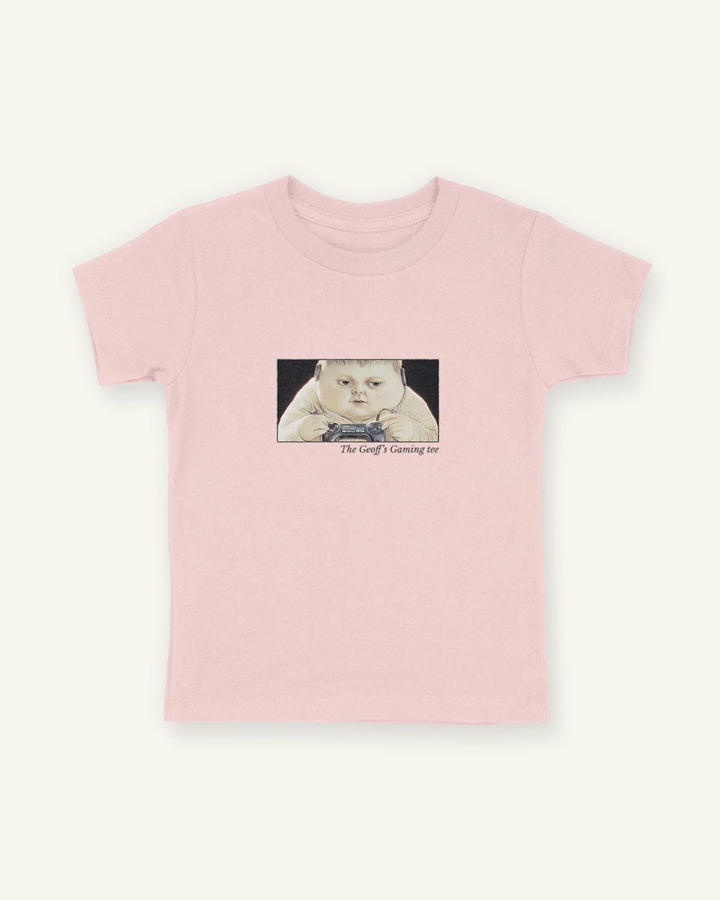 Pink fitted children's tee with a framed front print of the boy Geoff gaming with the title below in Libre Baskerville.
