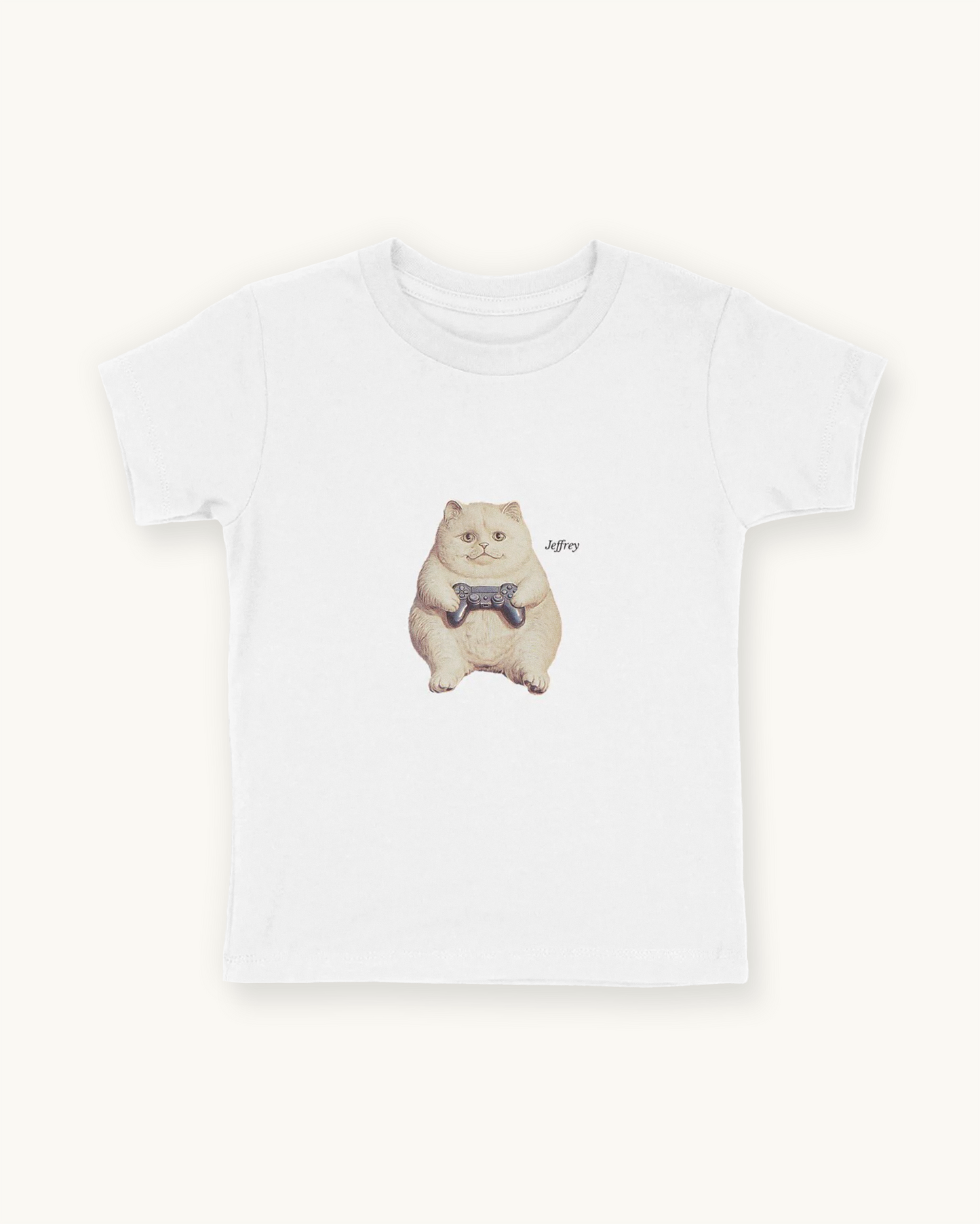 Fitted children's white tee with a front print cutout of the cat Jeffrey gaming with this name in Libre Baskerville.