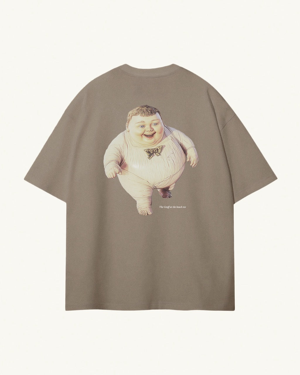 Back of light kaki / brown organic cotton Geoff & Jeffrey unisex t-shirt with drop shoulders and a large graphic backprint of the chubby boy Geoff running on the beach, with the title printed below in elegant font Libre Baskerville. The shirt has a cool aesthetic.