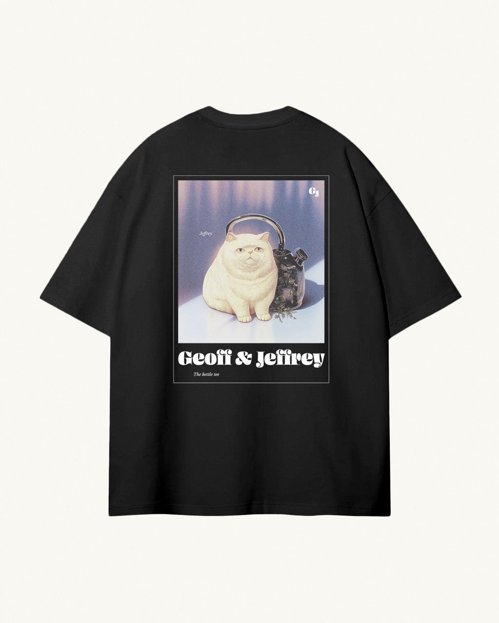 black organic cotton Geoff & Jeffrey unisex t-shirt with drop shoulders  and a large graphic backprint of the weird cat Jeffrey with his kettle. With the brandname and title printed below. The t-shirt has a cool aesthetic.