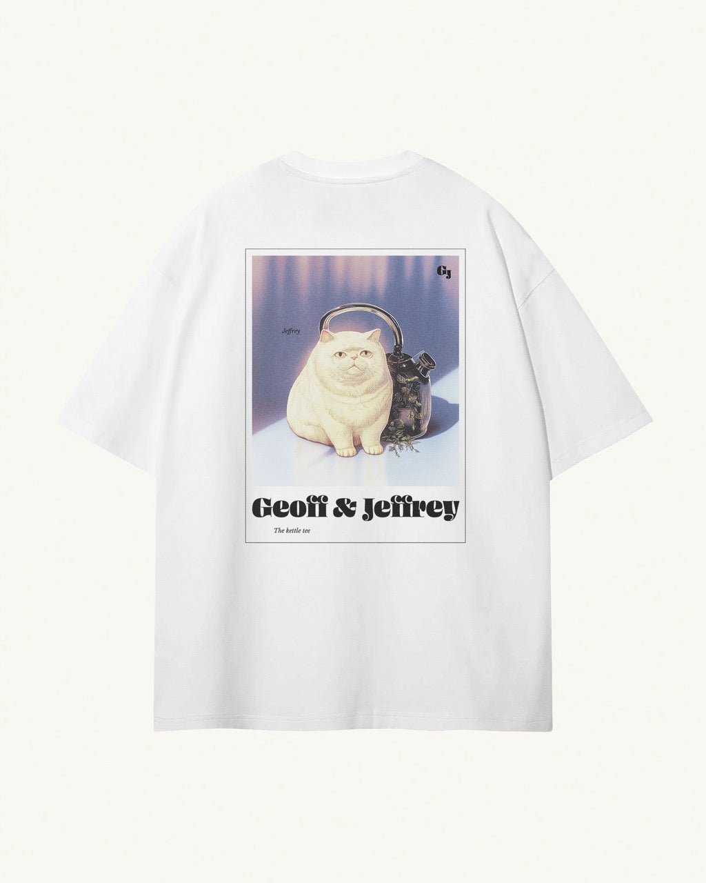 white organic cotton Geoff & Jeffrey unisex t-shirt with drop shoulders  and a large graphic backprint of the weird cat Jeffrey with his kettle. With the brandname and title printed below. The t-shirt has a cool aesthetic.