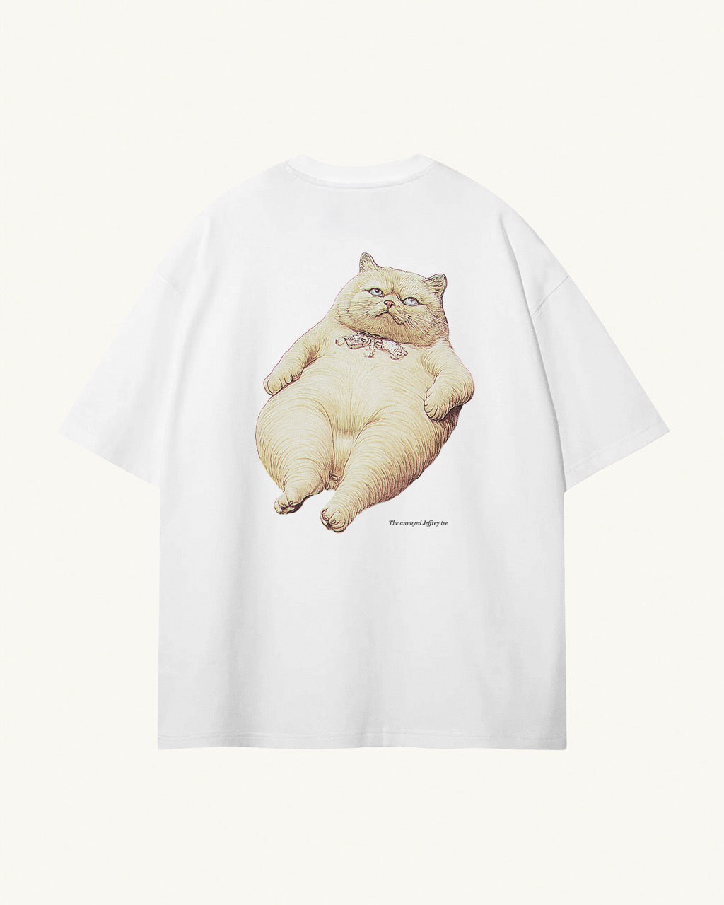 White organic cotton Geoff & Jeffrey unisex t-shirt with drop shoulders and a large graphic backprint of a funny fat cat (Jeffrey) looking annoyed, and the title printed below. The shirt has a cool aesthetic.
