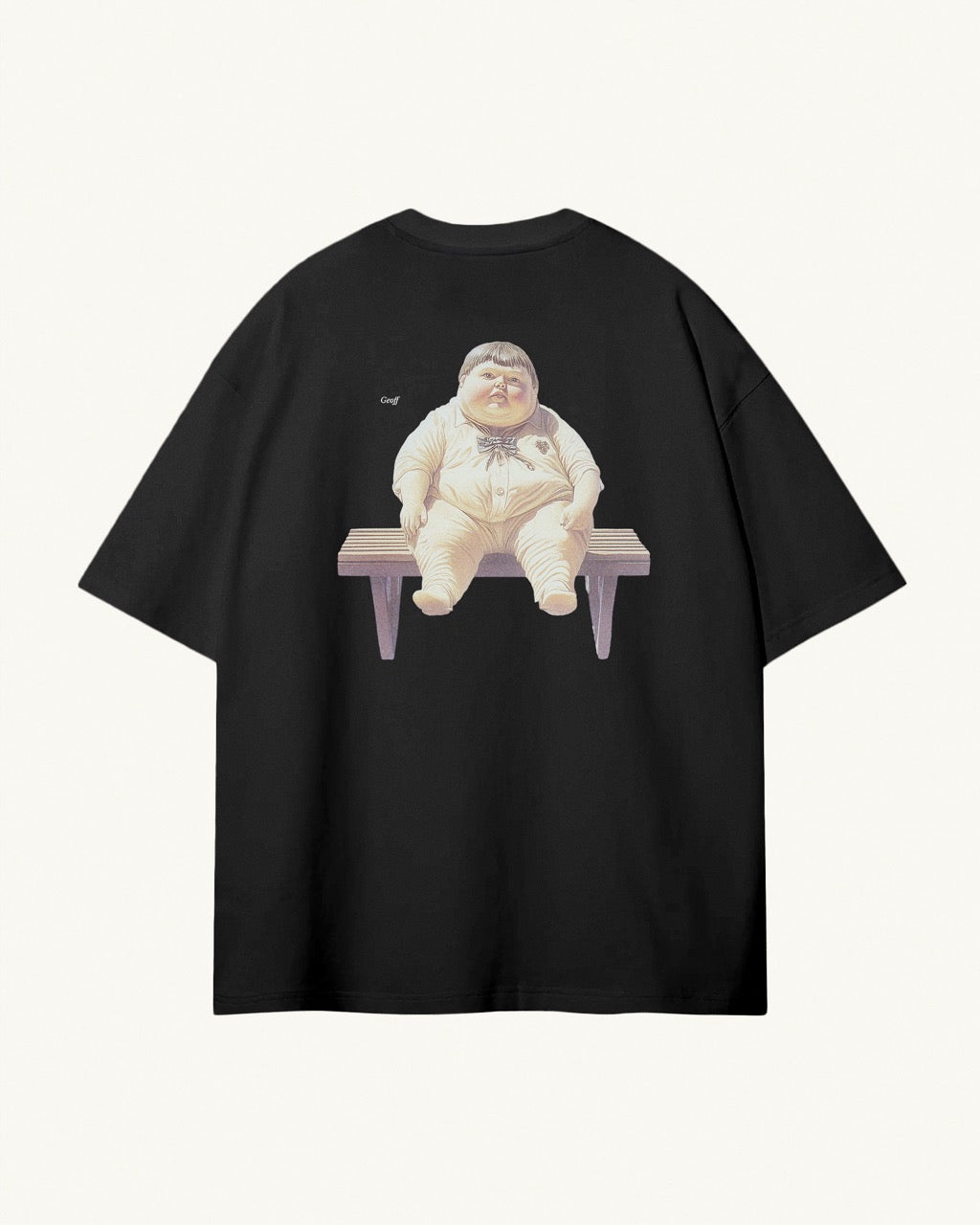 Back of black organic cotton Geoff & Jeffrey unisex t-shirt with drop shoulders and a large graphic backprint of the chubby boy Geoff waiting on a bench, with his name printed aside in elegant font Libre Baskerville. The shirt has a cool aesthetic.