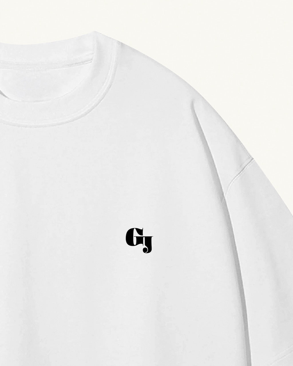 white organic cotton Geoff & Jeffrey, unisex t-shirt with drop shoulders and the brand logo on the front. The shirt has a minimal design.