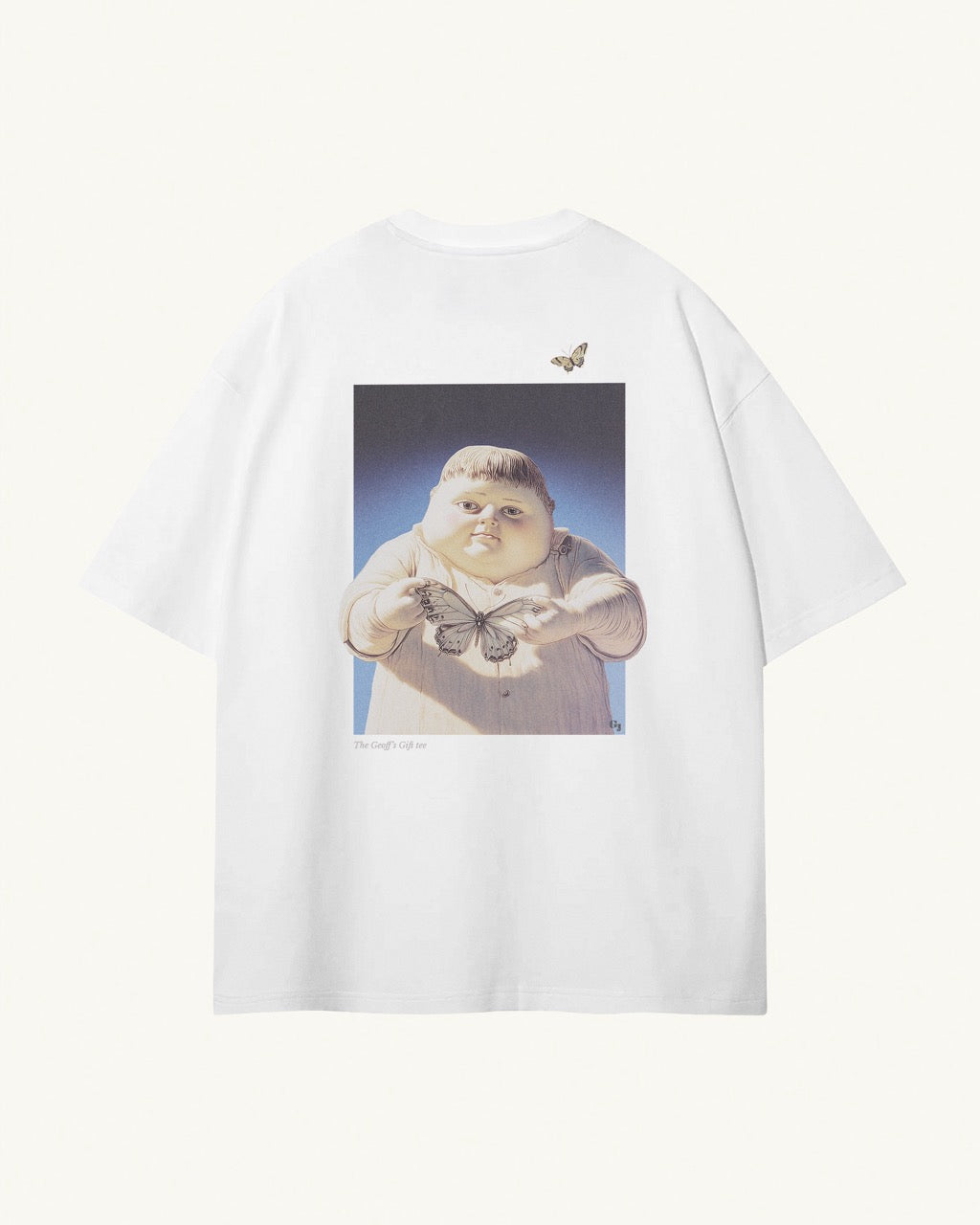 white organic cotton Geoff & Jeffrey unisex t-shirt with drop shoulders and a large graphic backprint of the jolly boy Geoff holding a butterfly,with the title printed below. The shirt has a cool aesthetic.