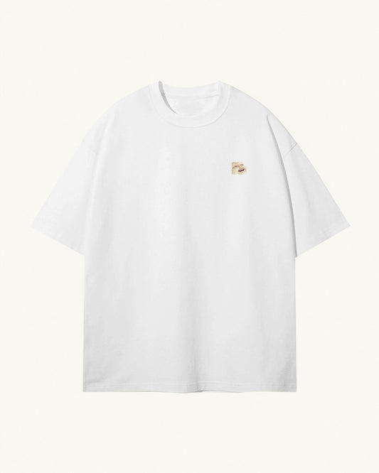 white organic cotton Geoff & Jeffrey unisex t-shirt with drop shoulders. The front of the shirt has a small close up of Geoff’s face and a minimal design.