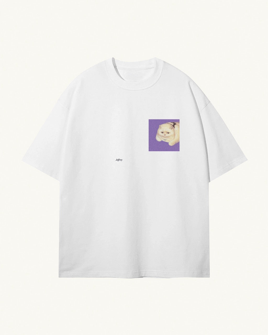 white organic cotton Geoff & Jeffrey, unisex t-shirt with drop shoulders and the funny cat Jeffrey on a purple square on the front. The shirt has a minimal design.