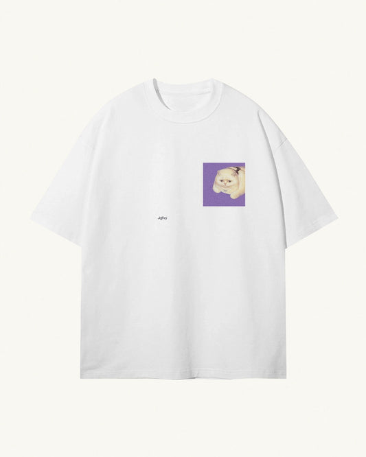 white organic cotton Geoff & Jeffrey, unisex t-shirt with drop shoulders and the funny cat Jeffrey on a purple square on the front. The shirt has a minimal design.
