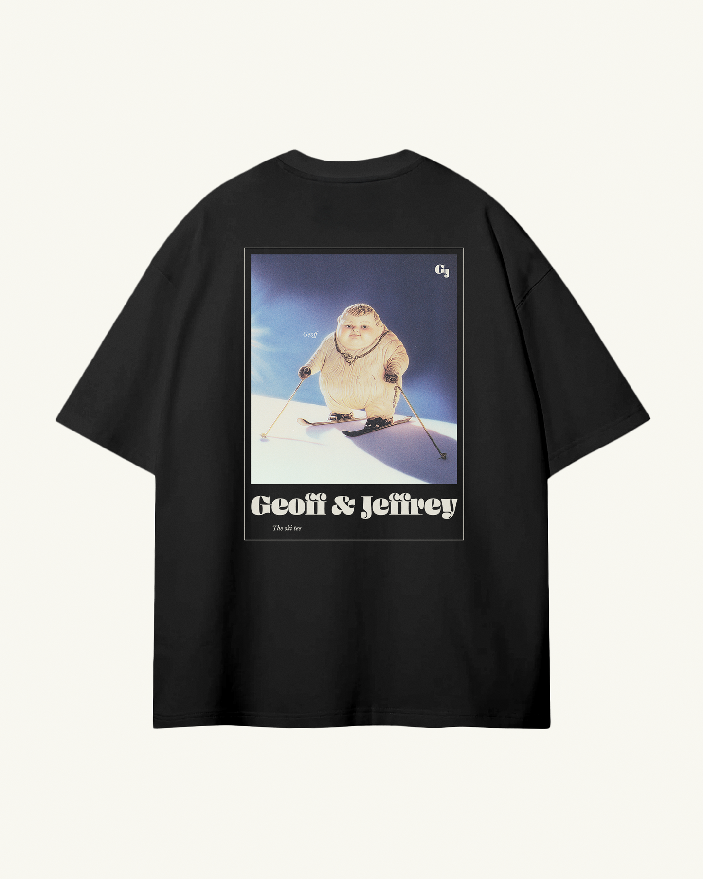 black organic cotton Geoff & Jeffrey unisex t-shirt with drop shoulders  and a large graphic backprint of a joyful, proud boy Geoff on skies, with the brandname and title printed below. The t-shirt has a cool aesthetic.
