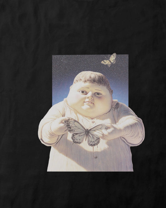 Close up of a women's black organic cotton Geoff & Jeffrey t-shirt with a small graphic print of a jolly, proud boy (Geoff) holding a butterfly in front of him. The t-shirt has a cute aesthetic.