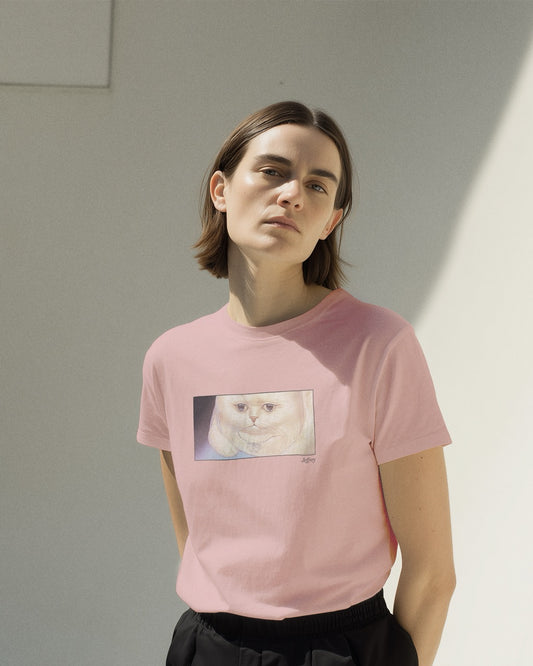Model in a women's soft pink organic cotton Geoff & Jeffrey t-shirt with a framed graphic print of a funny fat cat (Jeffrey) looking worried. With his name 'Jeffrey' subtly printed in Libre Baskerville below the image. The t-shirt has a cute and dreamy aesthetic.