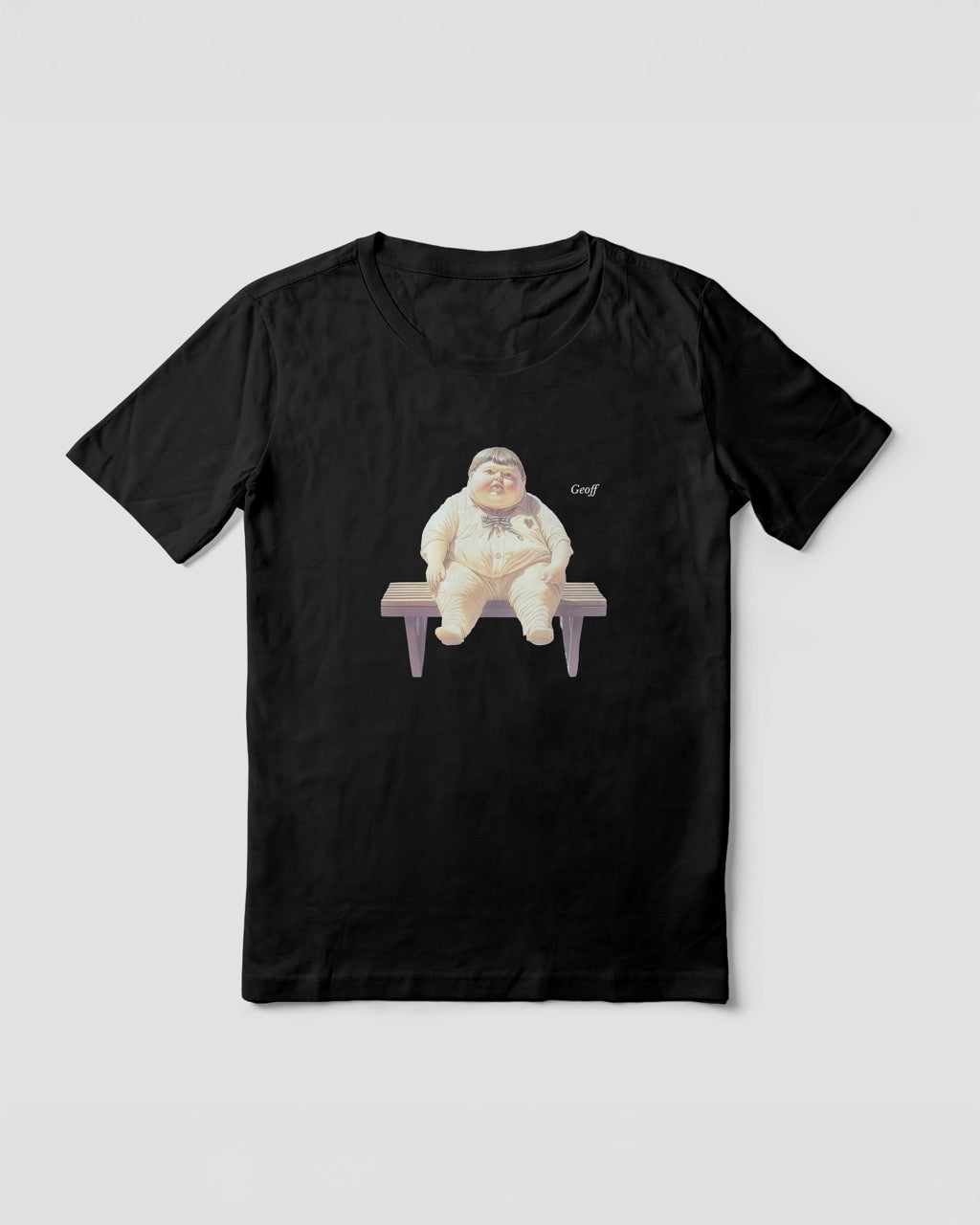Women's black organic cotton Geoff & Jeffrey t-shirt with a graphic print of a jolly, proud boy (Geoff) sitting on a bench, waiting, with his name 'Geoff' subtly printed in Libre Baskerville next to the image. The t-shirt has a weird aesthetic