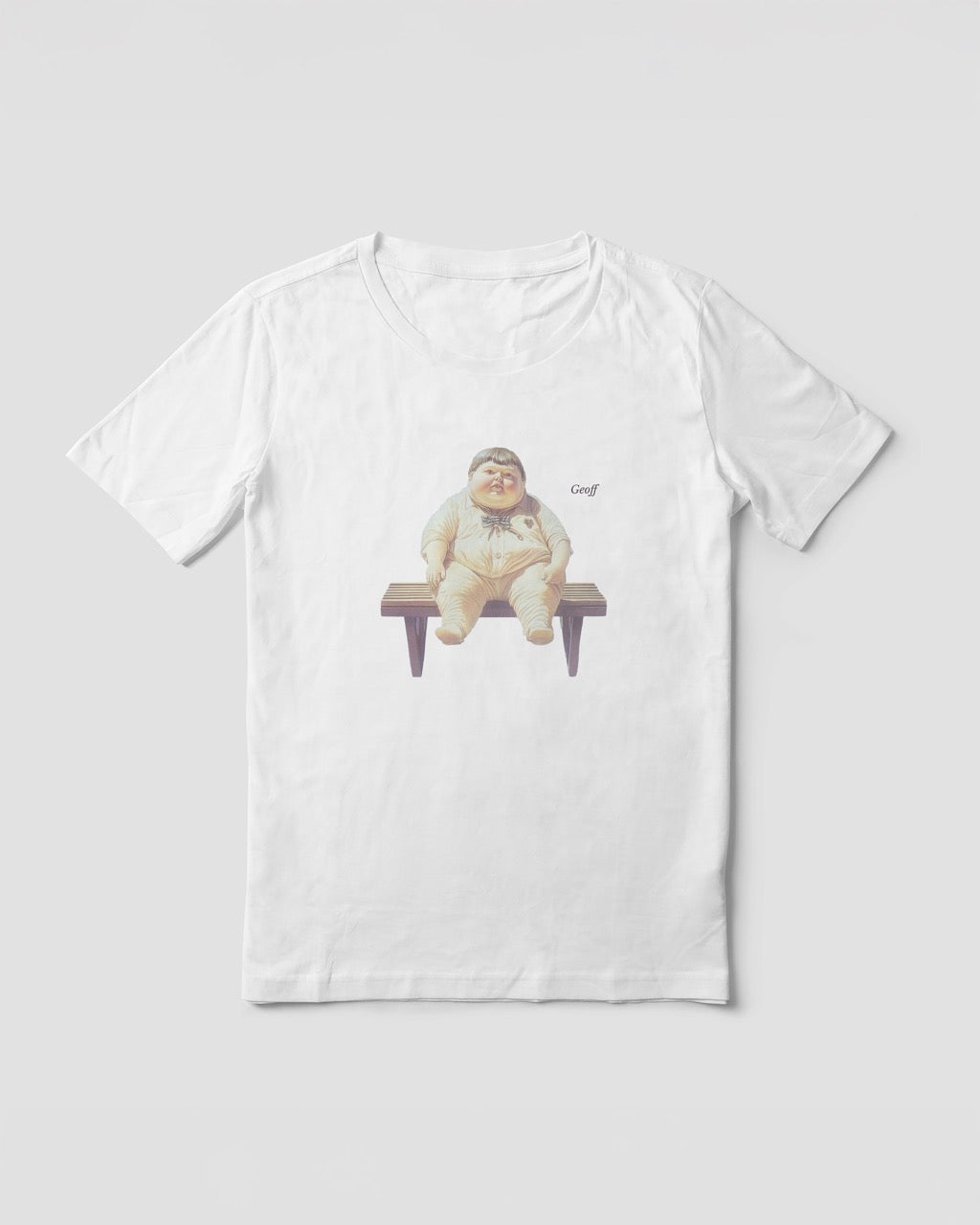 Women's white organic cotton Geoff & Jeffrey t-shirt with a graphic print of a jolly, proud boy (Geoff) sitting on a bench, waiting, with his name 'Geoff' subtly printed in Libre Baskerville next to the image. The t-shirt has a weird aesthetic