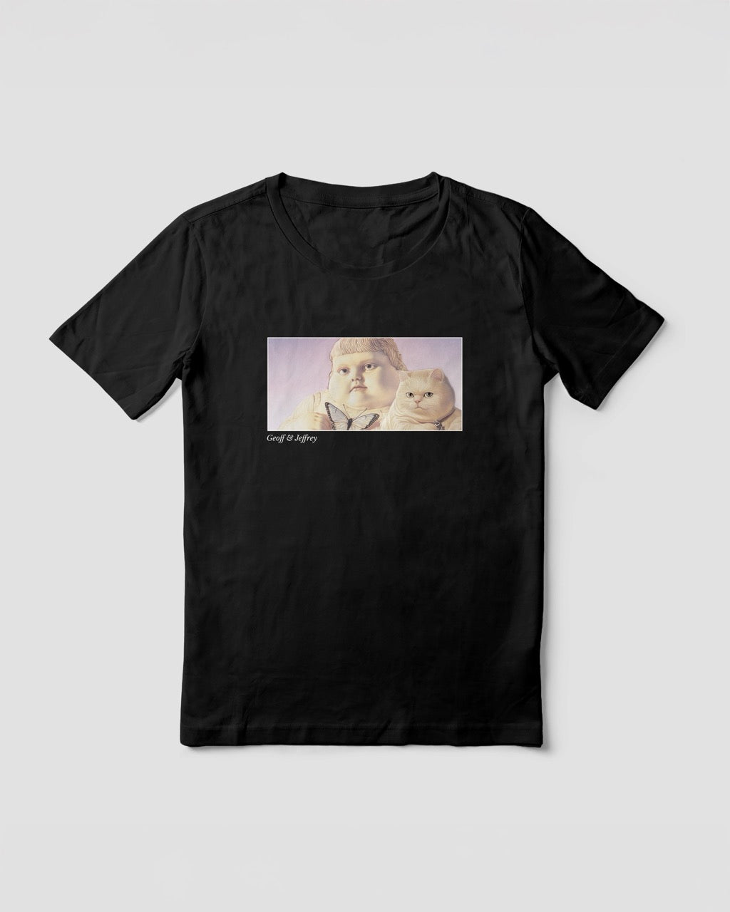 Women's black organic cotton Geoff & Jeffrey t-shirt with a framed graphic print of the jolly, proud boy (Geoff) and his funny fat cat (Jeffrey), holding a butterfly, with there names subtly printed in Libre Baskerville below the image. The t-shirt has a dreamy aesthetic.