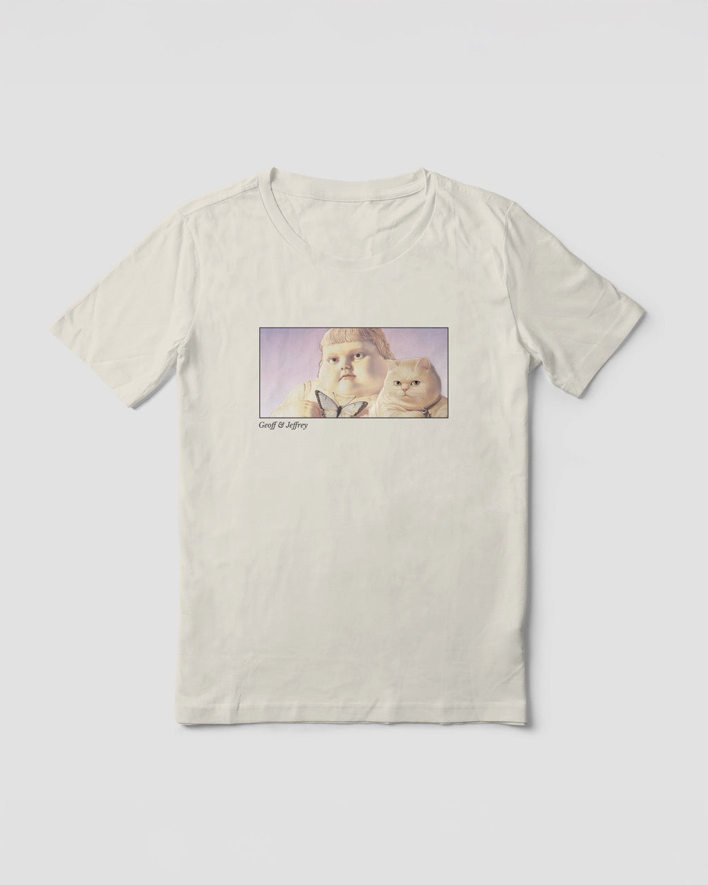Women's off-white natural organic cotton Geoff & Jeffrey t-shirt with a framed graphic print of the jolly, proud boy (Geoff) and his funny fat cat (Jeffrey), holding a butterfly, with there names subtly printed in Libre Baskerville below the image. The t-shirt has a dreamy aesthetic.