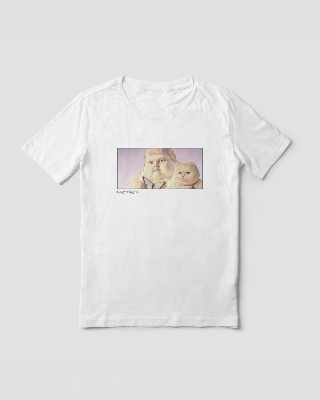 Women's white organic cotton Geoff & Jeffrey t-shirt with a framed graphic print of the jolly, proud boy (Geoff) and his funny fat cat (Jeffrey), holding a butterfly, with there names subtly printed in Libre Baskerville below the image. The t-shirt has a dreamy aesthetic.