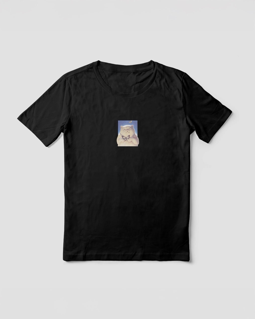 Women's black organic cotton Geoff & Jeffrey t-shirt with a small graphic print of a funny fat cat (Jeffrey) holding a butterfly. The t-shirt has a cute aesthetic.