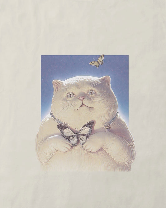 Close up of a women's off-white natural organic cotton Geoff & Jeffrey t-shirt with a small graphic print of a funny fat cat (Jeffrey) holding a butterfly. The t-shirt has a cute aesthetic.