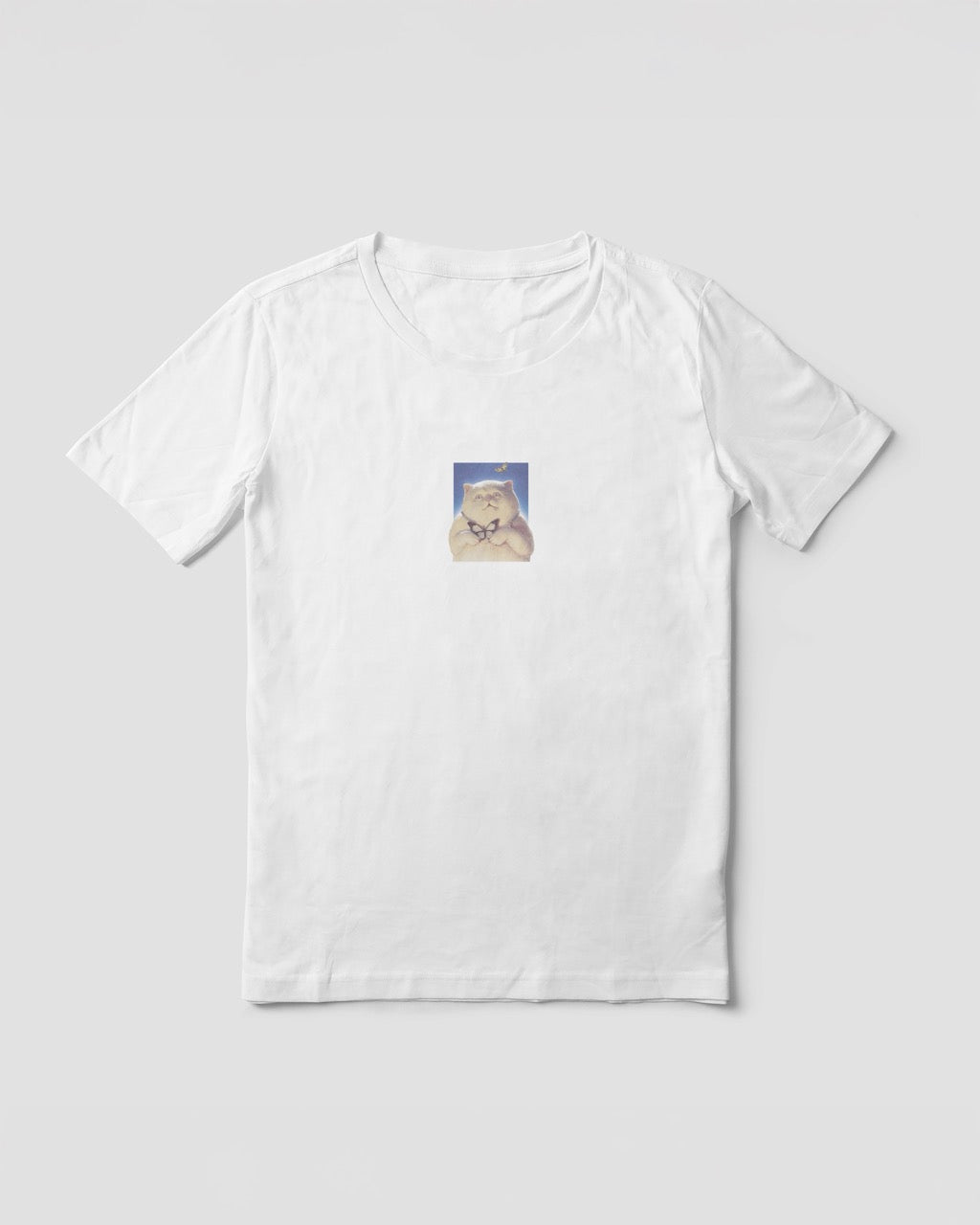Women's white organic cotton Geoff & Jeffrey t-shirt with a small graphic print of a funny fat cat (Jeffrey) holding a butterfly. The t-shirt has a cute aesthetic.