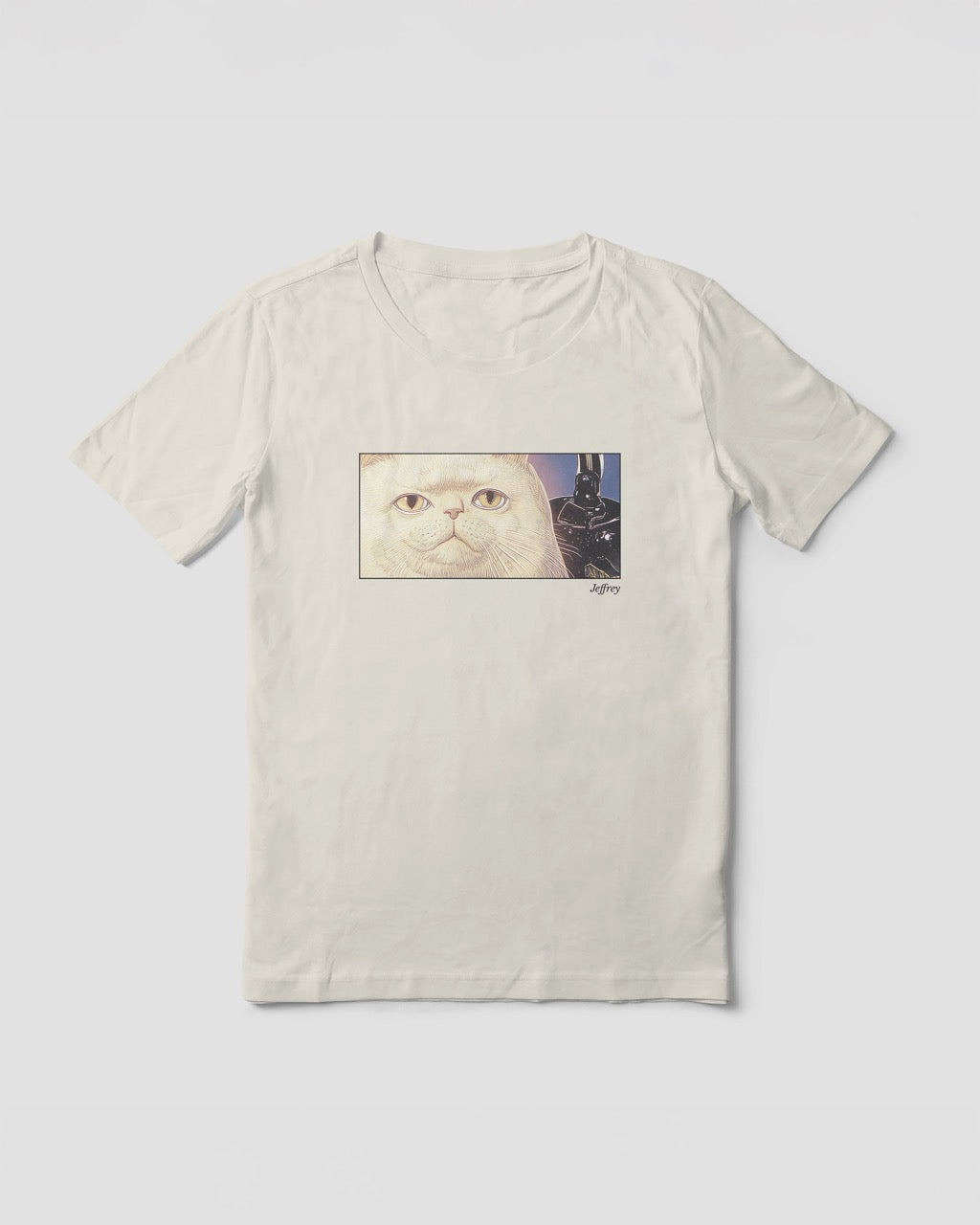 Women's off-white natural organic cotton Geoff & Jeffrey t-shirt with a framed graphic print of a funny fat cat (Jeffrey) poker-faced and a kettle at his side. With his name 'Jeffrey' subtly printed in Libre Baskerville below the image. The t-shirt has a cute aesthetic