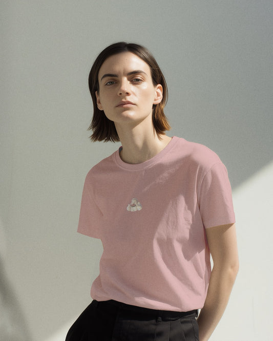 model in a women's soft pink organic cotton Geoff & Jeffrey t-shirt with a graphic print of a jolly, proud boy (Geoff) smiling and eating a watermelon, with his name 'Geoff' subtly printed in Libre Baskerville below the image. The t-shirt has a cute aesthetic.