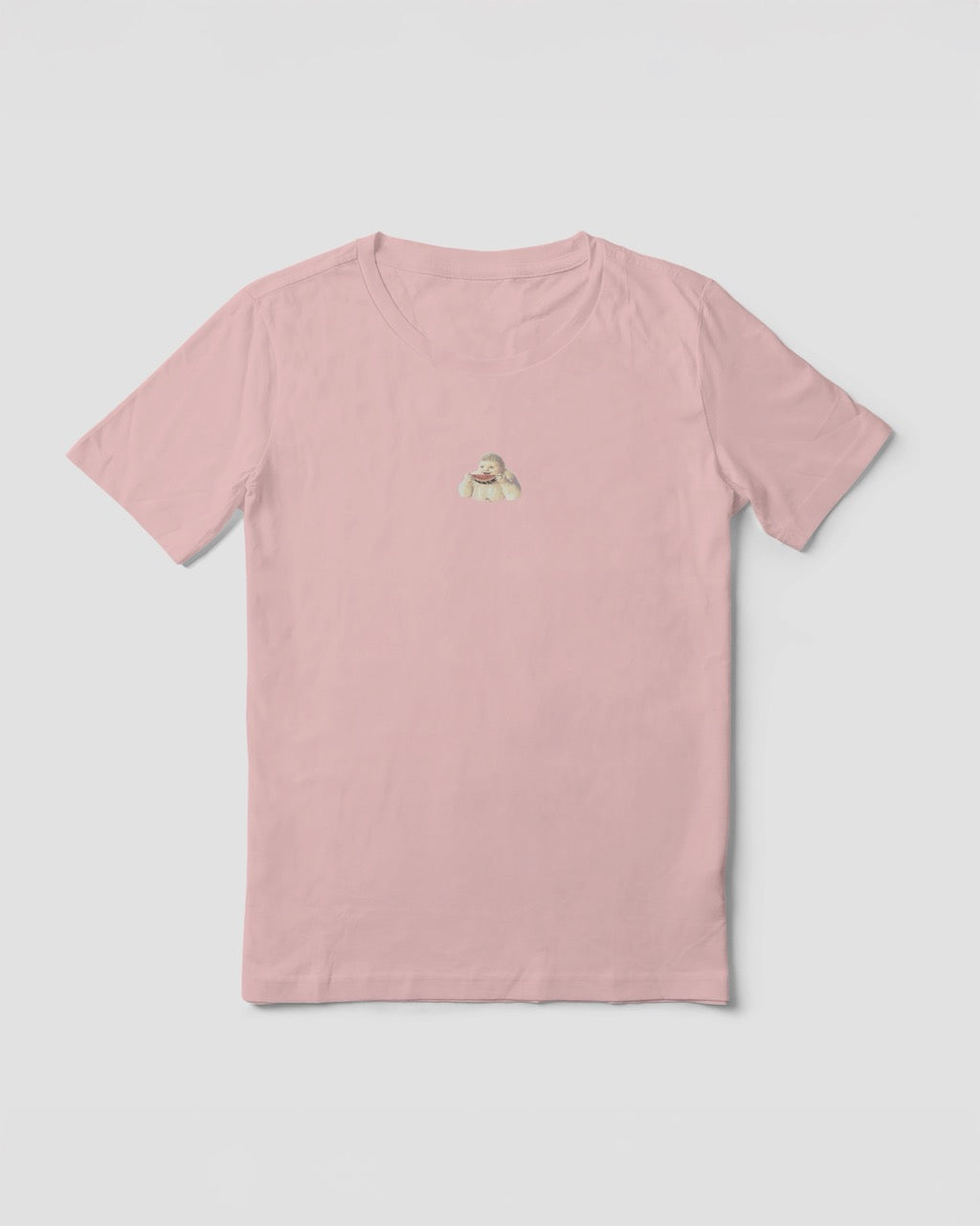 a women's soft pink organic cotton Geoff & Jeffrey t-shirt with a graphic print of a jolly, proud boy (Geoff) smiling and eating a watermelon, with his name 'Geoff' subtly printed in Libre Baskerville below the image. The t-shirt has a cute aesthetic.